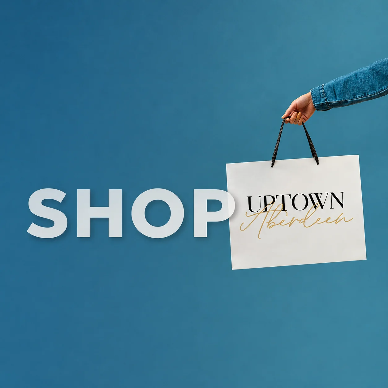 Shop Uptown Aberdeen: a hand holding an Uptown Aberdeen shopping bag